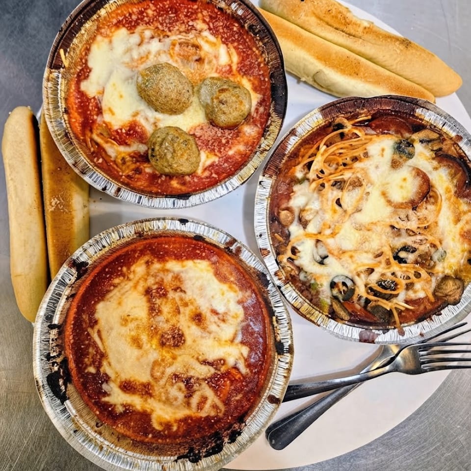 Pasta Flight with three baked pasta dishes and breadsticks.